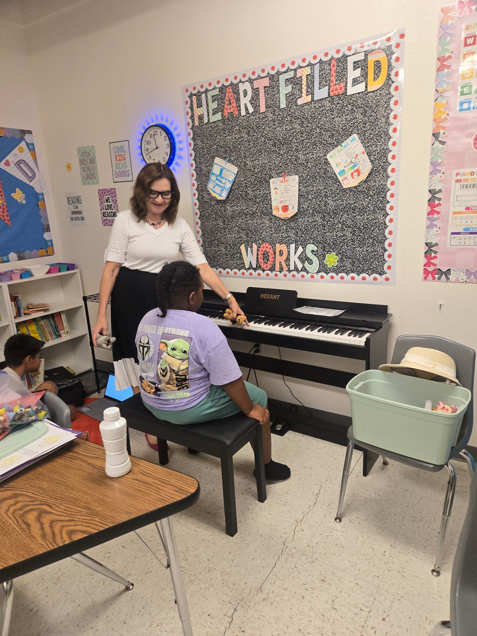 A student at Heart Filled Academy taking a piano lesson with an instructor